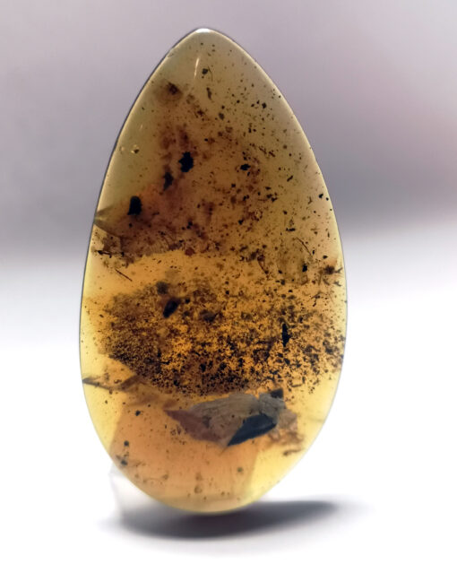 Large, flat, tear-drop shaped amber pendant with speckled amber inclusions (Cretaceous)